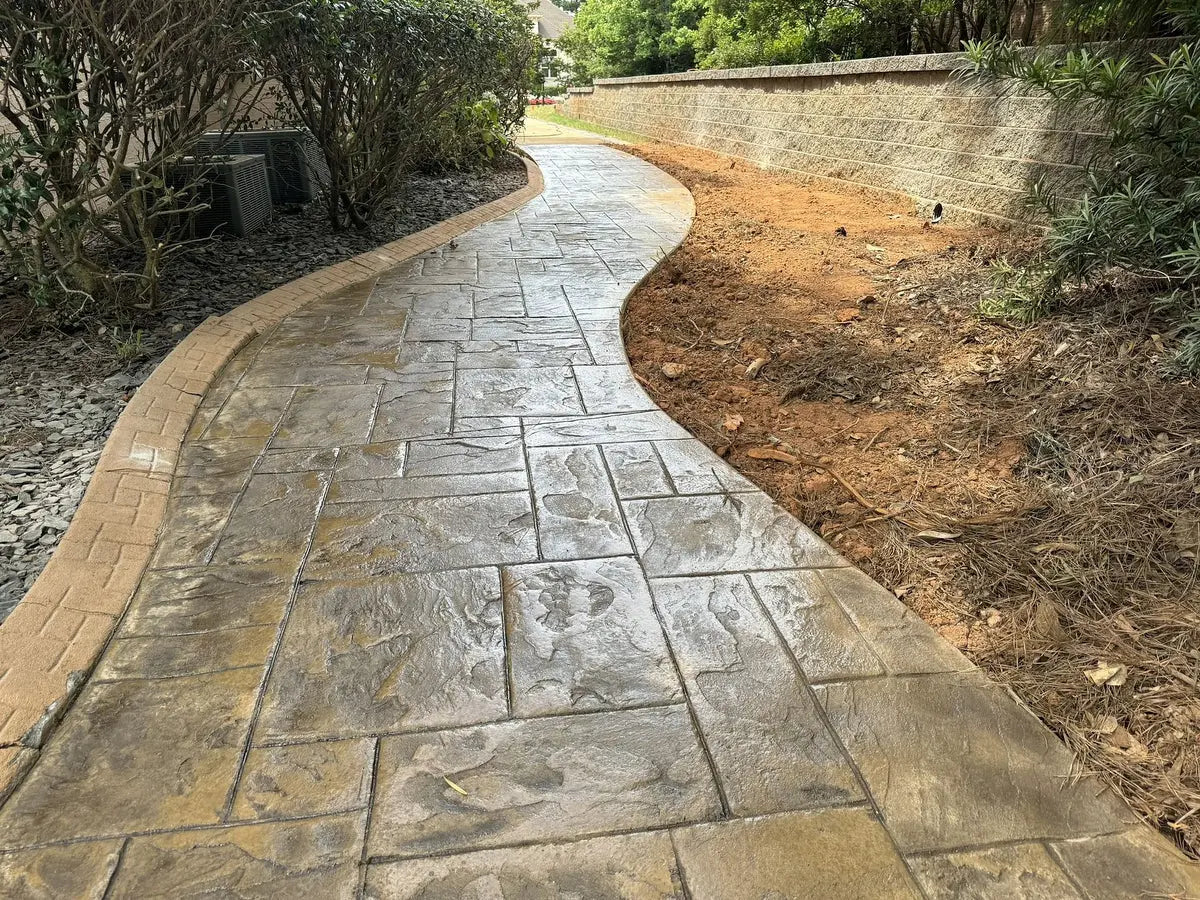 Finished stamped concrete walkway installed by Kingdom Builders